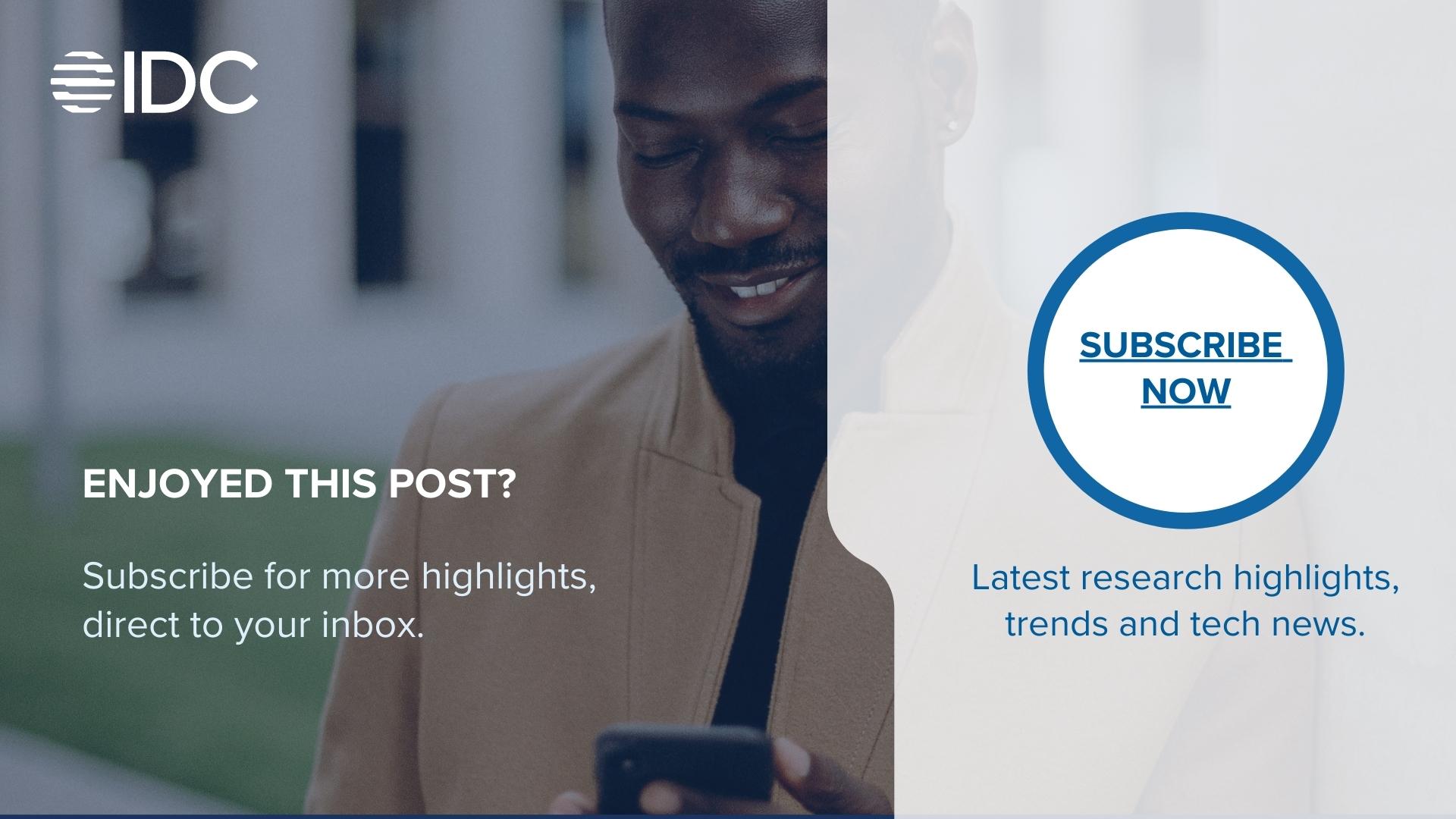 Male in wool coat reading on his mobile phone