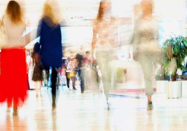 Blurred images of consumers walking in a shopping mall