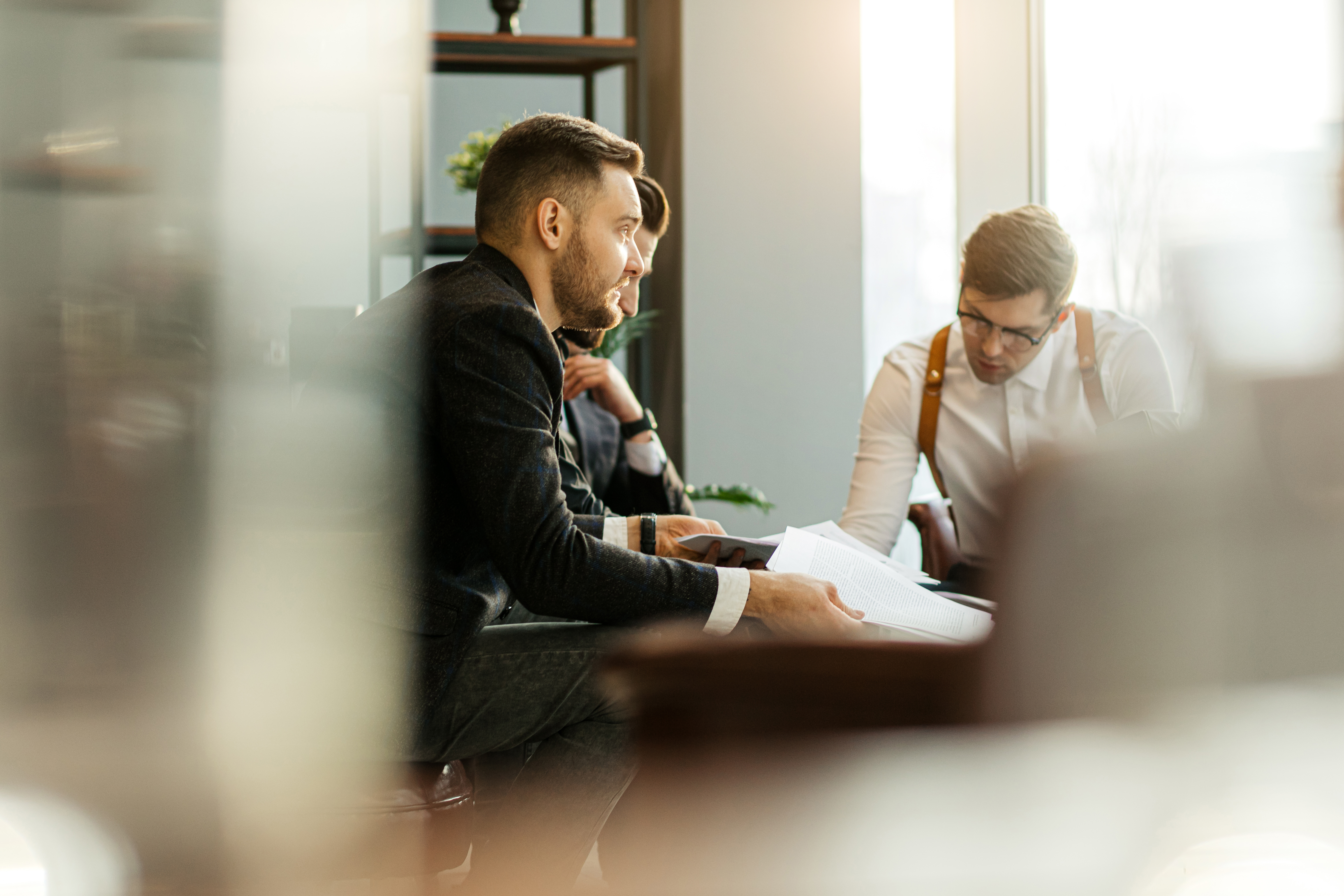Executives reviewing go-to-market strategy documents during an enterprise planning meeting