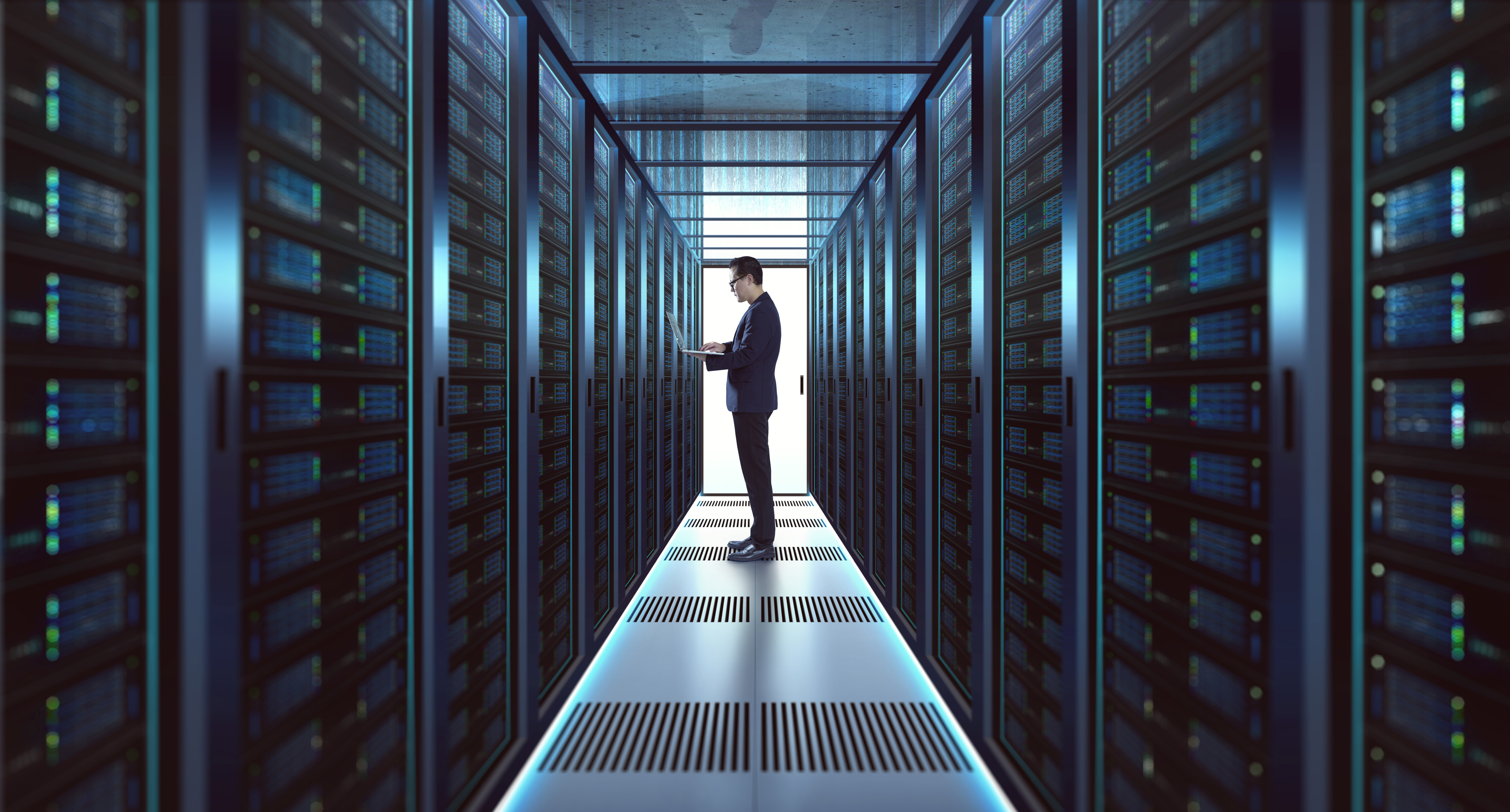 IT professional working in a datacenter aisle with server racks supporting AI and high-speed networking