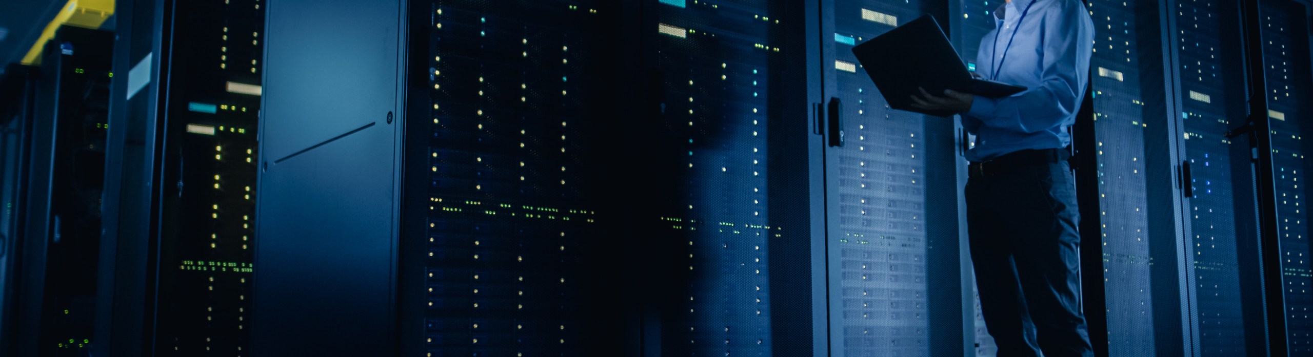 IT technician performing maintenance in an AI-optimized data center, illustrating the infrastructure demand driving semiconductor market growth in 2026.