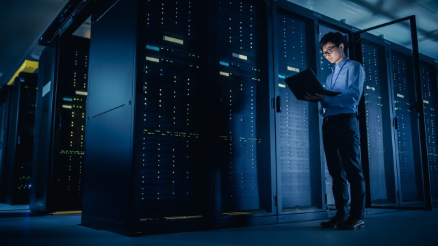 IT technician performing maintenance in an AI-optimized data center, illustrating the infrastructure demand driving semiconductor market growth in 2026.
