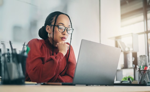 Woman looking doubtful over her computer
