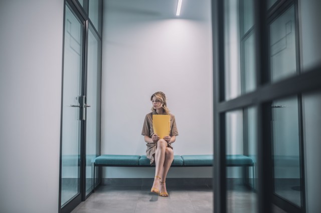 B2B buyer waiting in a corporate hallway — pipeline conversion friction